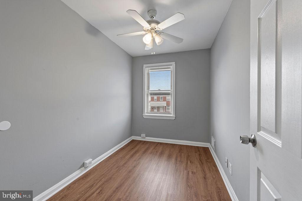 7308 Berkshire Road Baltimore, MD 21224 - Photo 21 of 40 wooden floor in an empty room with a window