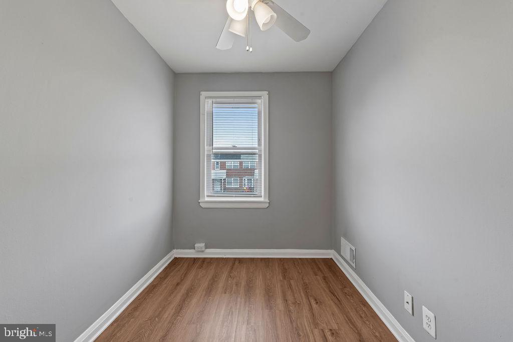 7308 Berkshire Road Baltimore, MD 21224 - Photo 25 of 40 wooden floor in an empty room with a window