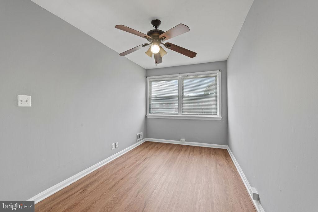 7308 Berkshire Road Baltimore, MD 21224 - Photo 29 of 40 wooden floor in an empty room with a window