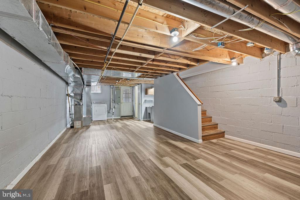 7308 Berkshire Road Baltimore, MD 21224 - Photo 33 of 40 a view of an empty room with wooden floor