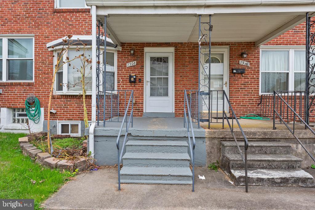 7308 Berkshire Road Baltimore, MD 21224 - Photo 4 of 40 a front view of a house with a garden