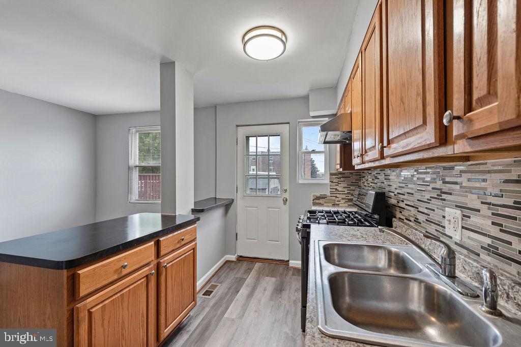 7308 Berkshire Road Baltimore, MD 21224 - Photo 5 of 40 a kitchen that has a sink and a stove