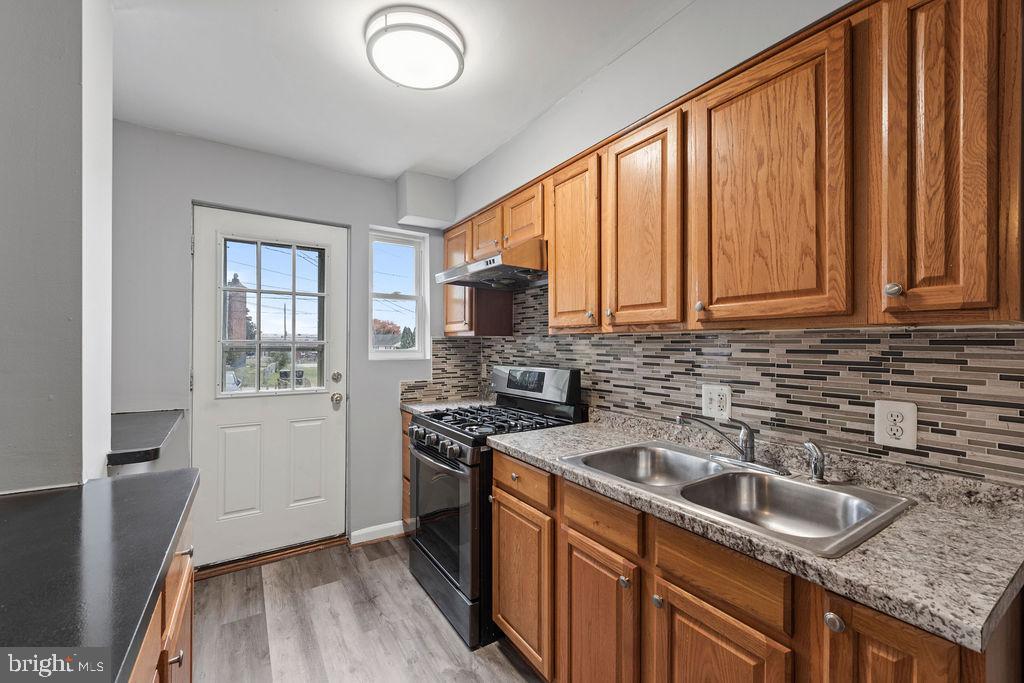 7308 Berkshire Road Baltimore, MD 21224 - Photo 8 of 40 a kitchen that has a sink cabinets counter space and stainless steel appliances