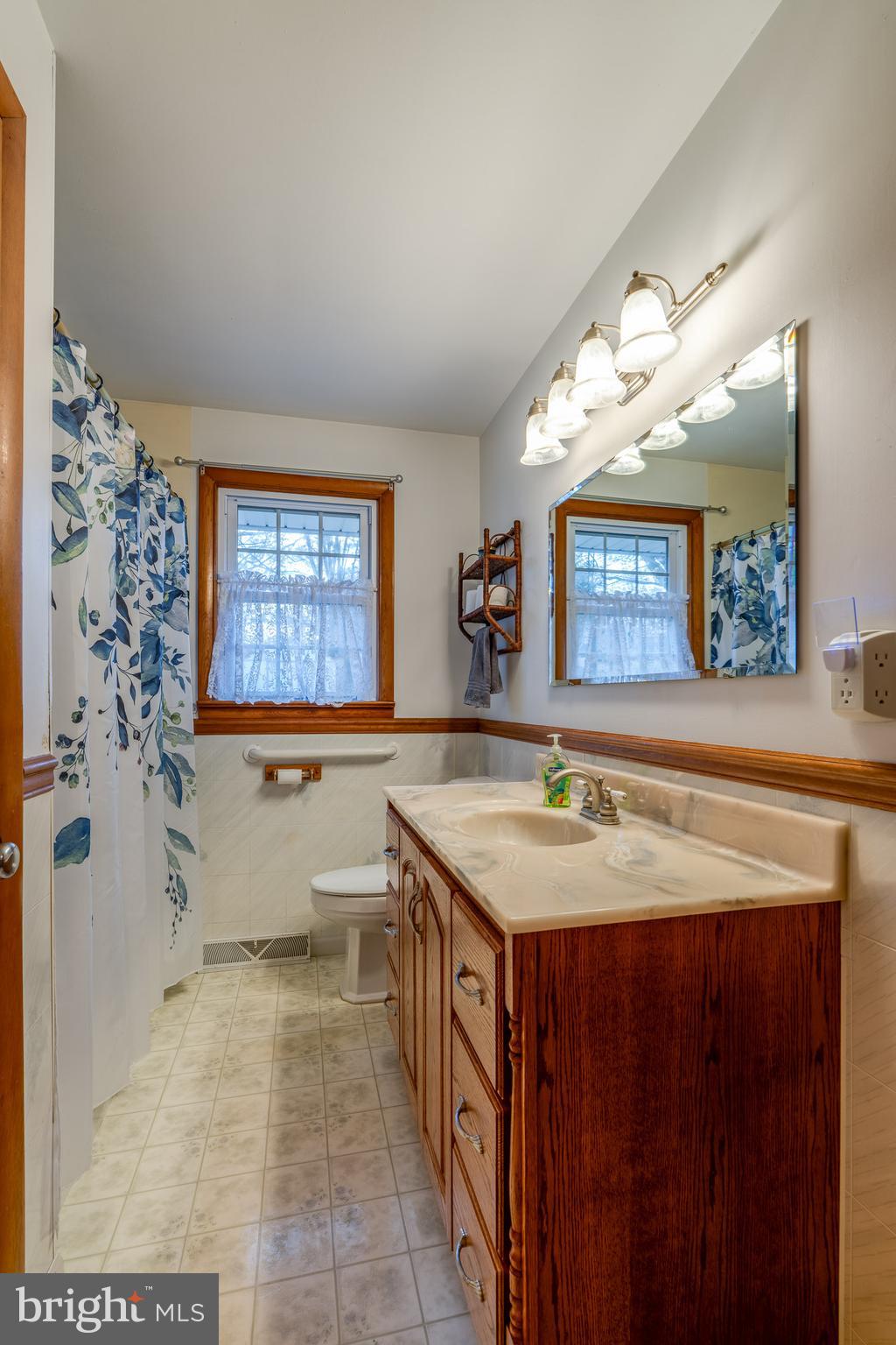 2 Snyder Hill Road Lititz, PA 17543 - Photo 32 of 46 a bathroom with a granite countertop sink a mirror a bathtub and a shower