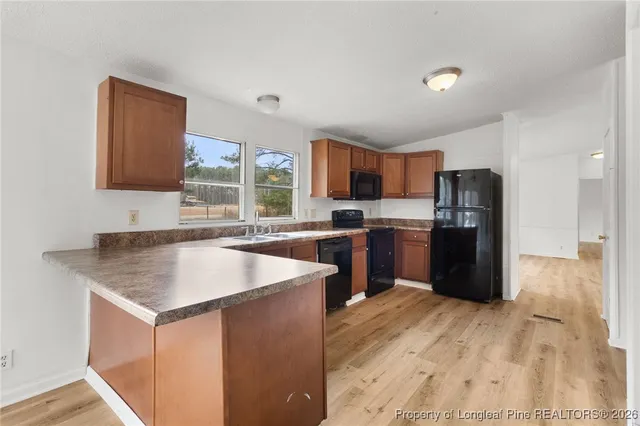 a kitchen with a sink a counter top space and stainless steel appliances