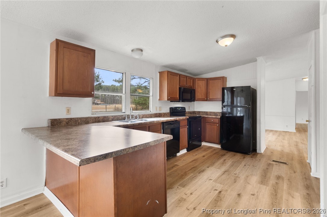 180 Branch Road Red Springs, NC 28377 - Photo 11 of 32 a kitchen with a sink a counter top space and stainless steel appliances