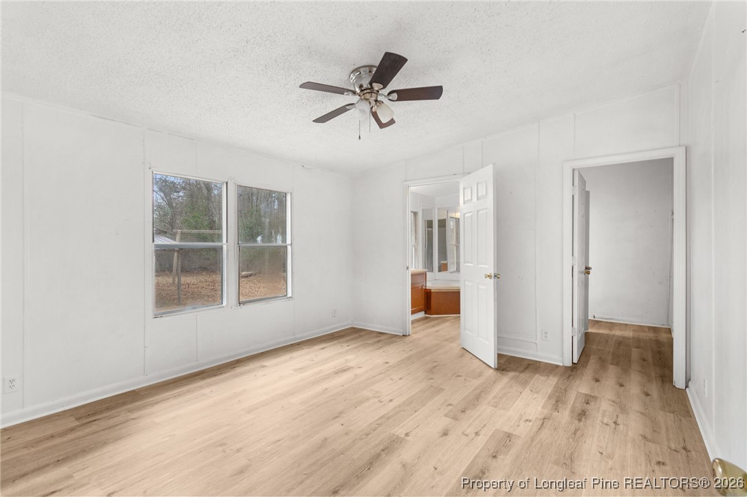180 Branch Road Red Springs, NC 28377 - Photo 15 of 32 a view of empty room with wooden floor and ceiling fan