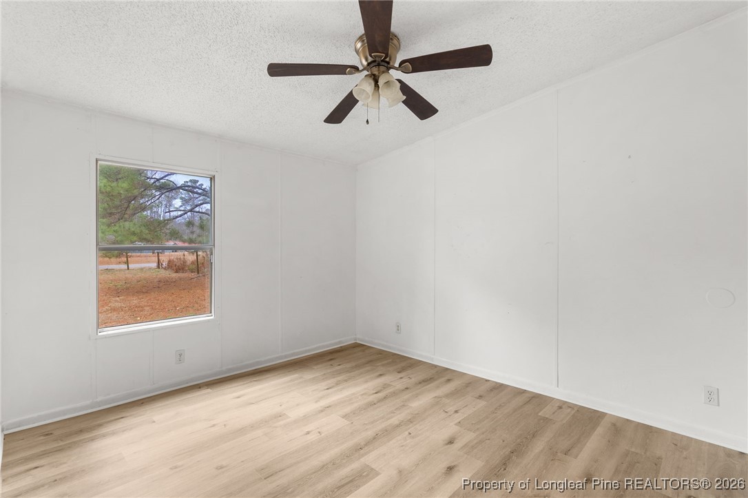 180 Branch Road Red Springs, NC 28377 - Photo 22 of 32 an empty room with a window and a fan