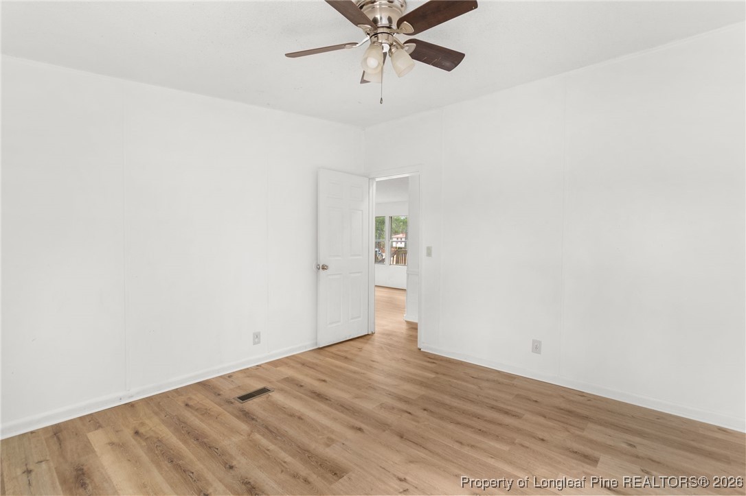 180 Branch Road Red Springs, NC 28377 - Photo 27 of 32 a view of a room with wooden floor and ceiling fan