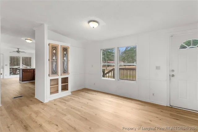 an empty room with windows and pillars in it