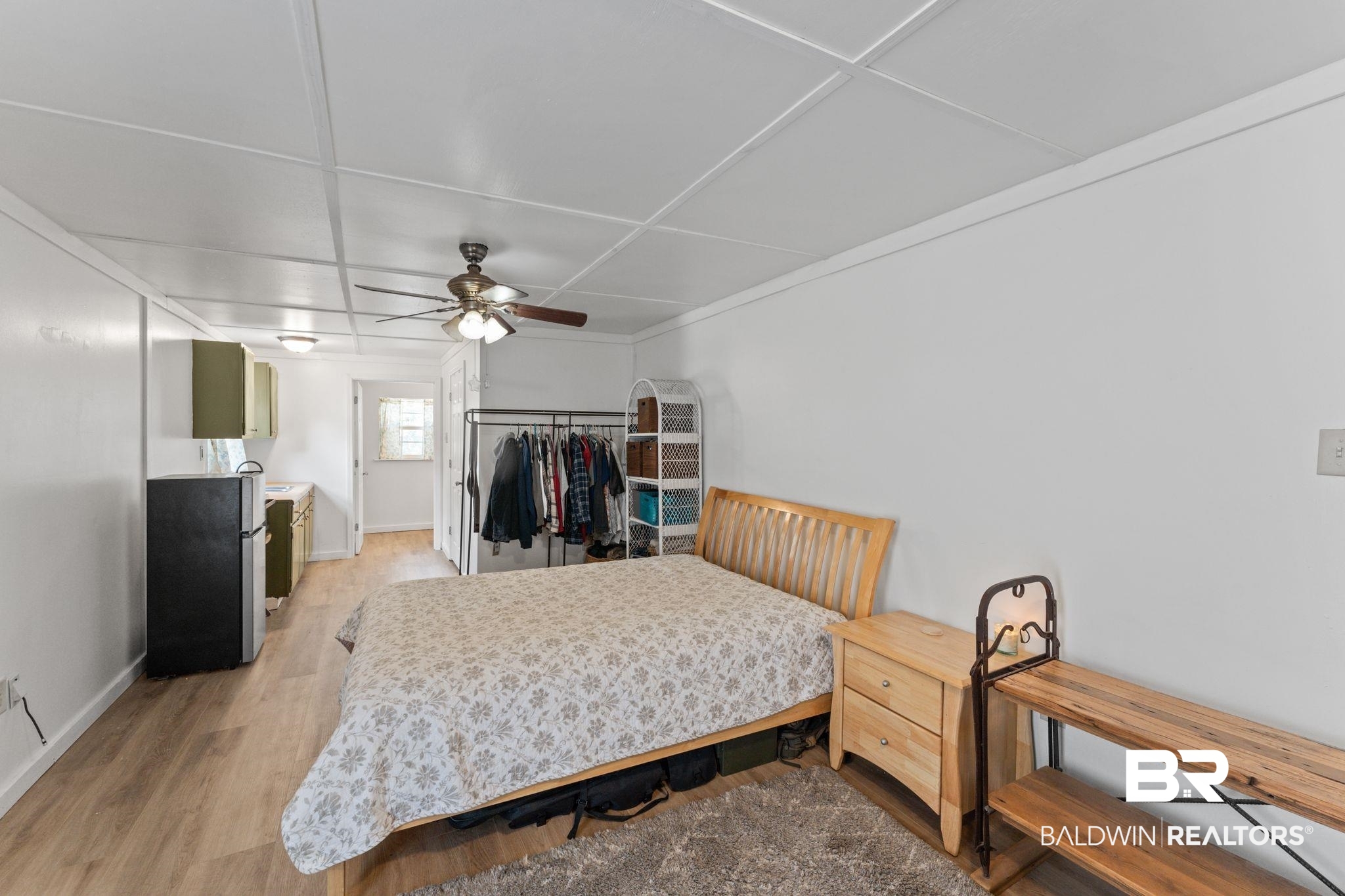 10785 Gregg Road Semmes, AL 36575 - Photo 34 of 35 Bedroom featuring light wood-style flooring, freestanding refrigerator, and ceiling fan