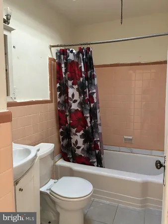 a bathroom with a toilet and a shower curtain