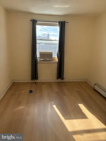 a view of a room with wooden floor and cabinet