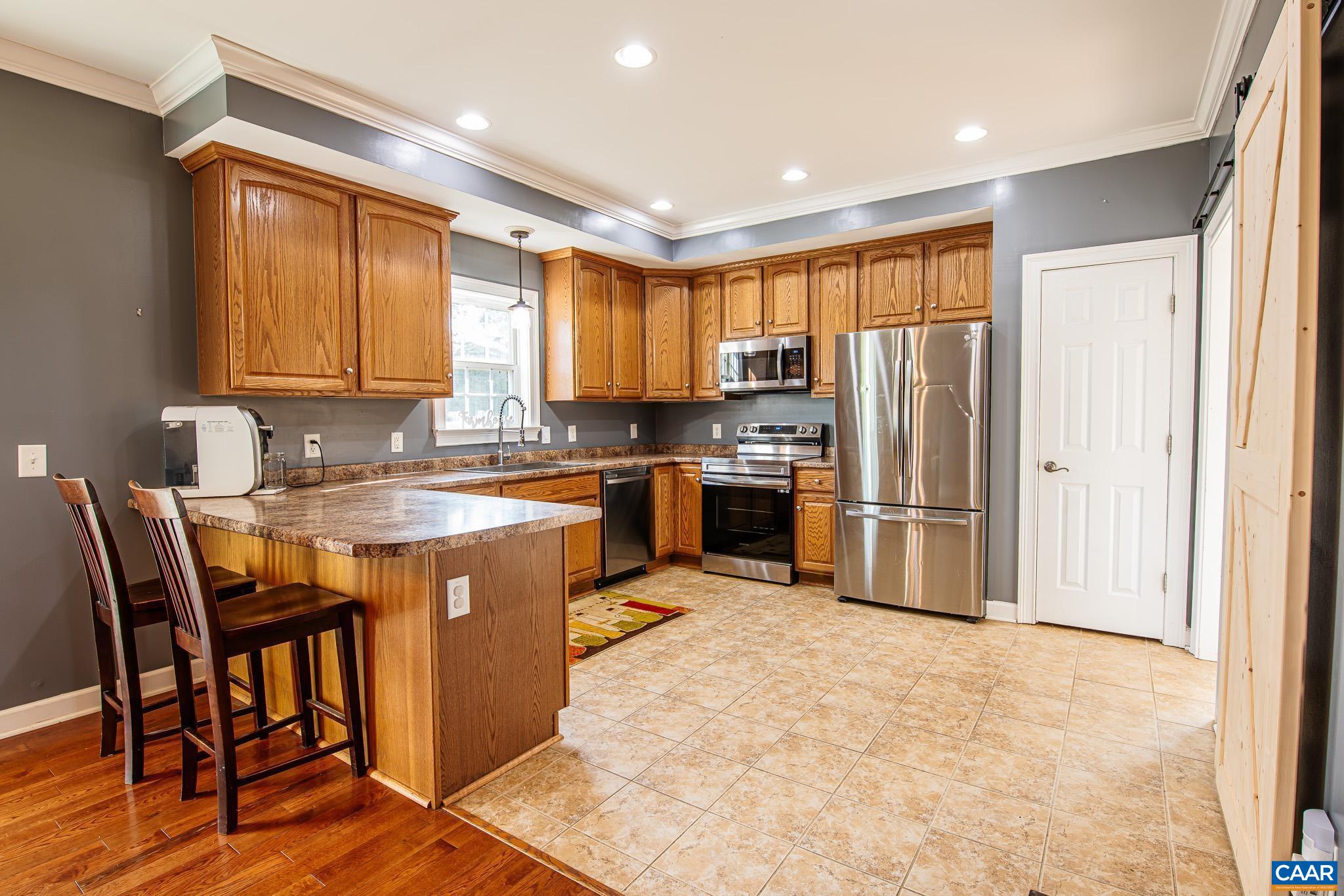 2644 Union Church Road Buckingham, VA 23921 - Photo 19 of 59 a kitchen with stainless steel appliances granite countertop a stove a refrigerator a sink a dining table and chairs