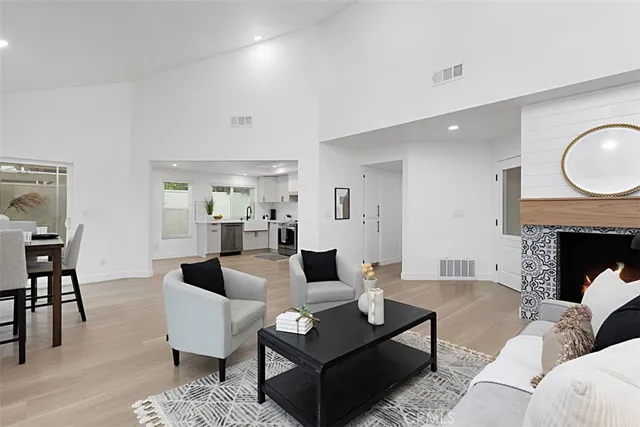 a living room with furniture a rug and a fireplace