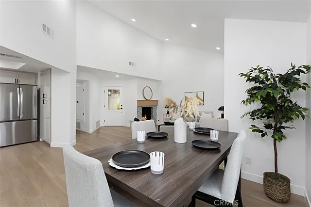 a kitchen with a table and a potted plant