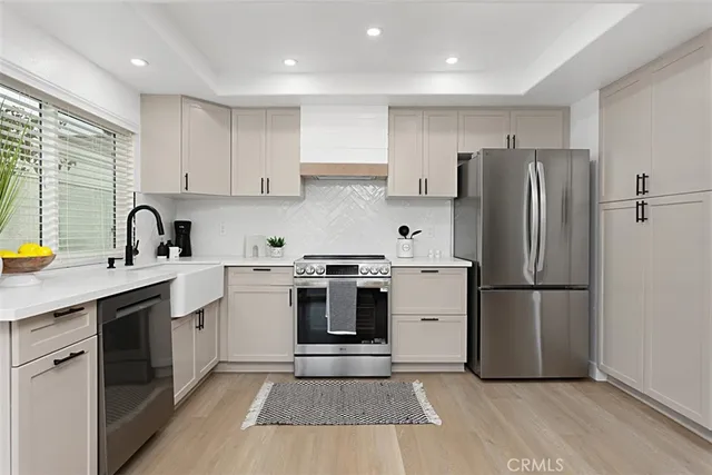a kitchen with a refrigerator sink and stove