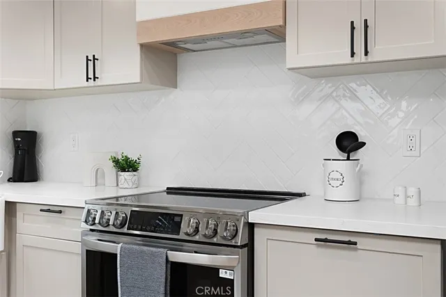 a kitchen with a stove and cabinets