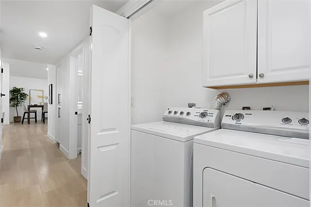 a view of storage and utility room with washer and dryer