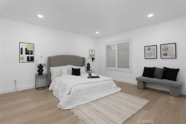 a bedroom with a large bed and a couch