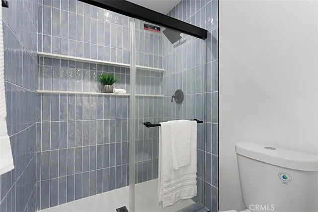 a bathroom with a shower and toilet