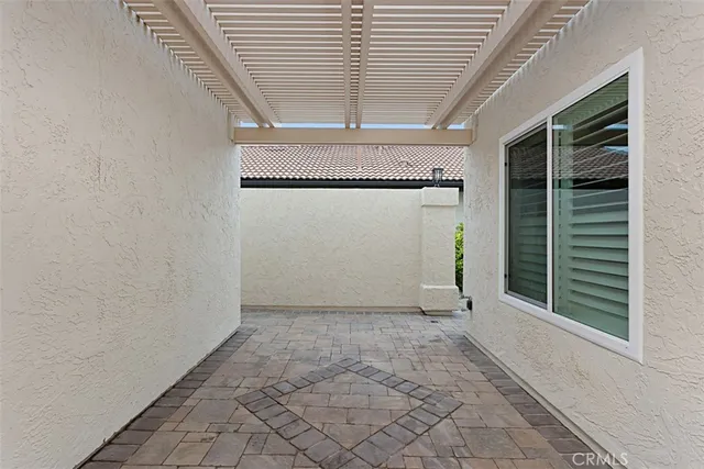a view of a patio with table and chairs and potted plants