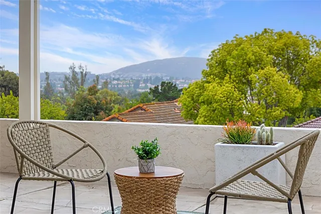 a view of a patio with table and chairs and potted plants