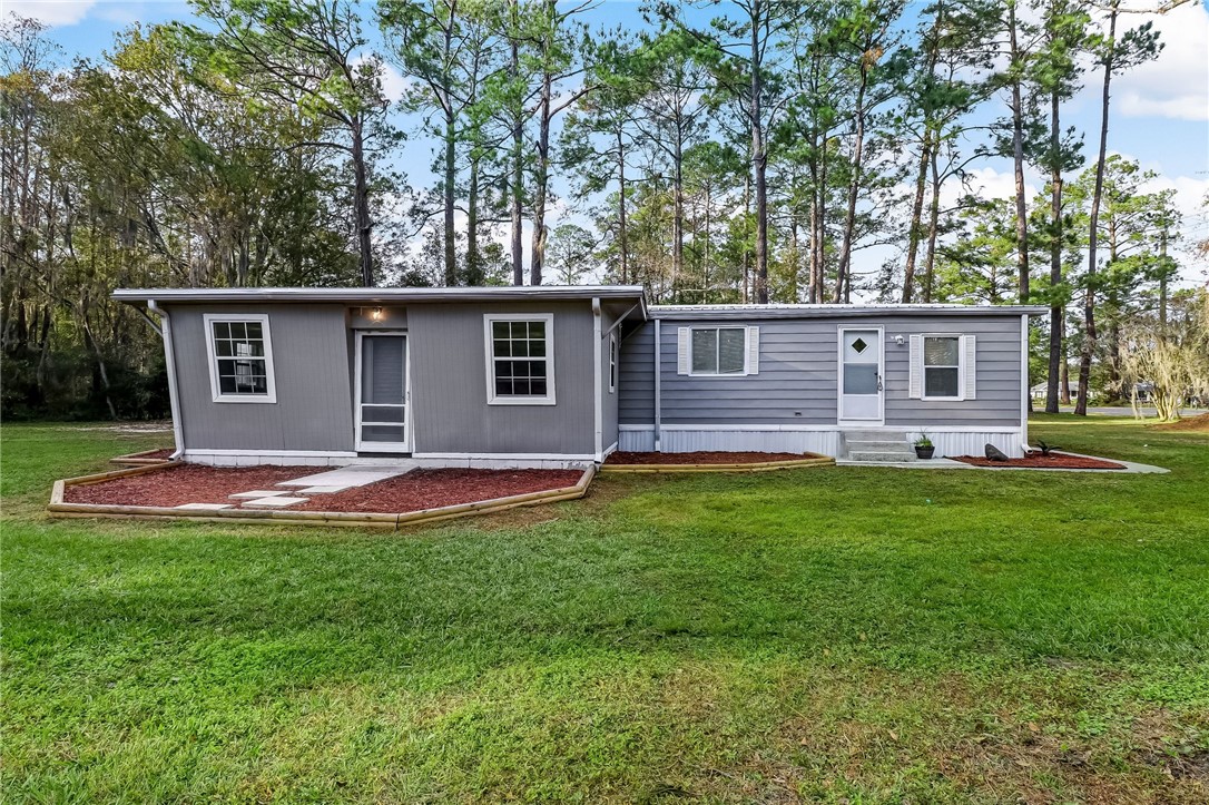 540821 Lem Turner Road Callahan, FL 32011 - Photo 2 of 35 a view of a house with a backyard and a large tree