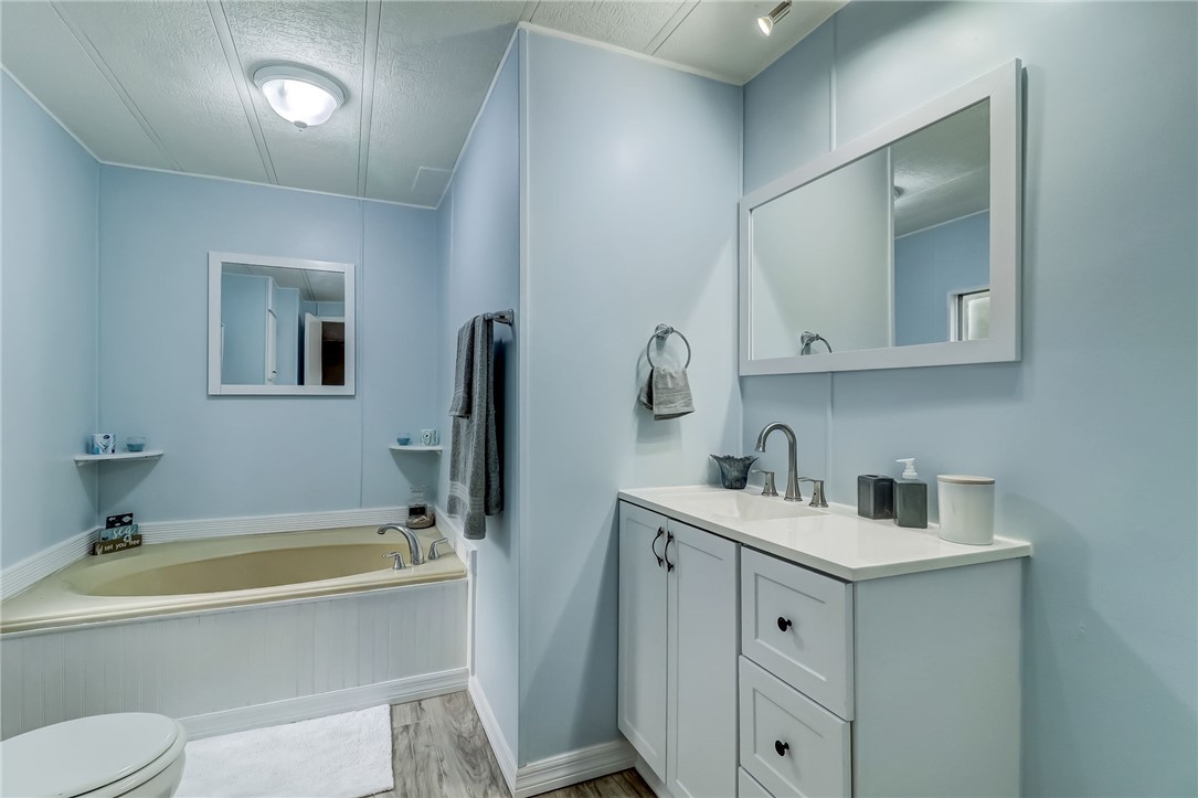 540821 Lem Turner Road Callahan, FL 32011 - Photo 27 of 35 a bathroom with a tub sink toilet and mirror