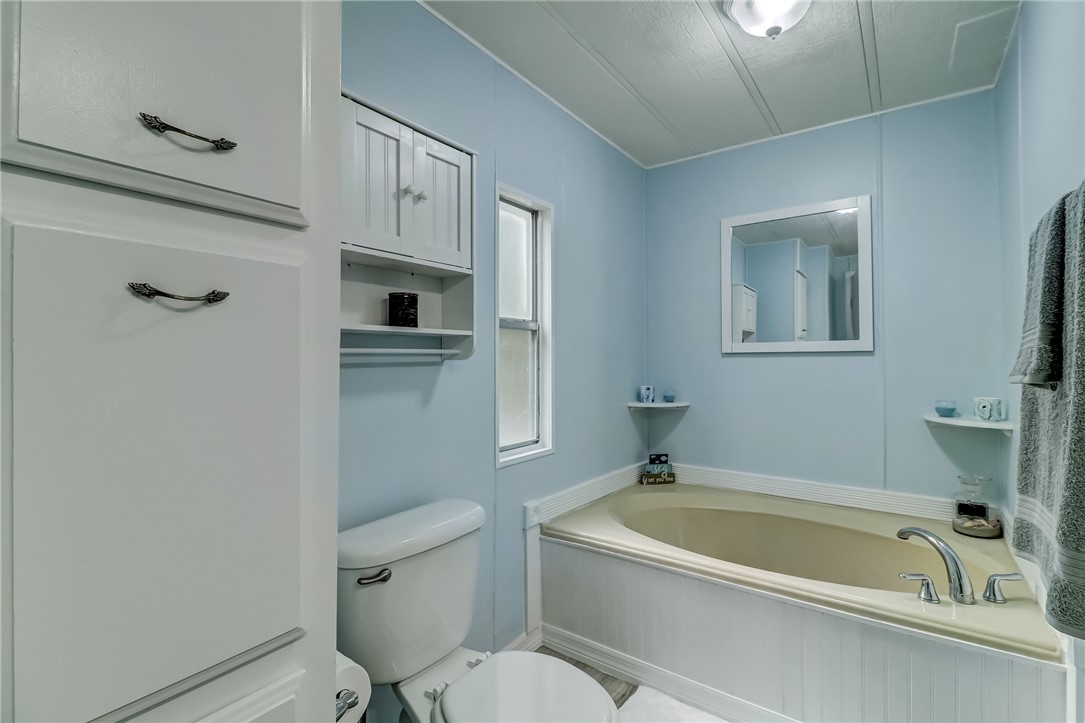540821 Lem Turner Road Callahan, FL 32011 - Photo 28 of 35 a bathroom with a granite countertop toilet a sink and bathtub