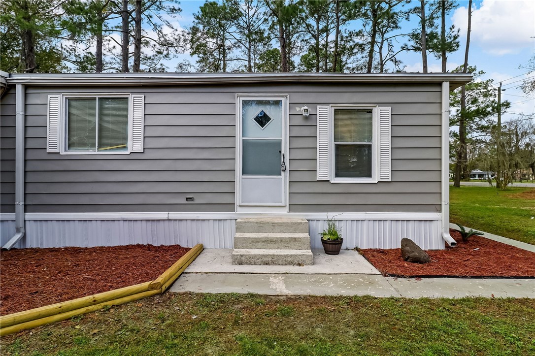 540821 Lem Turner Road Callahan, FL 32011 - Photo 10 of 35 a front view of a house with garden