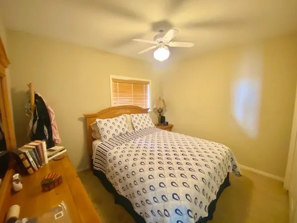 a hallway with a stove a microwave and a dining table with wooden floor
