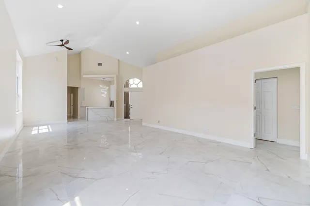 an empty room with closet and windows