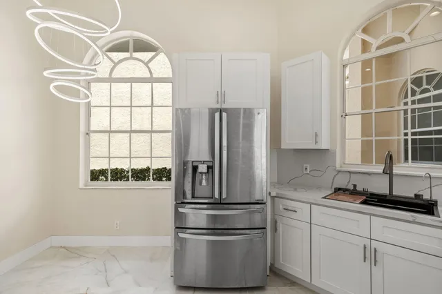 a kitchen with a refrigerator a sink and cabinets