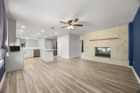 a view of an empty room with a kitchen and a kitchen counter top