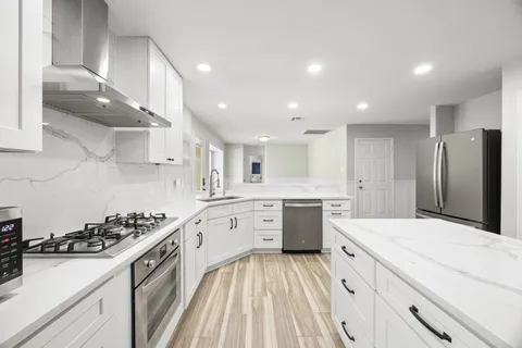 a kitchen with a sink stove and refrigerator