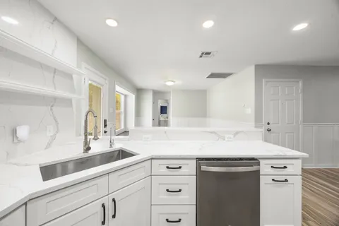 a kitchen with a sink and cabinets