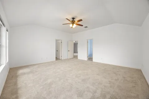 a view of a big room with ceiling fan and entryway