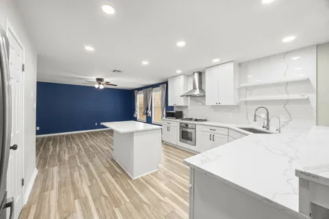 a kitchen with sink a stove and refrigerator