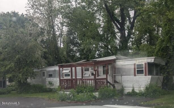 155 Water Street, Unit 5 Lee, MA 01238 - Photo 1 of 6 front view of a house with a garden
