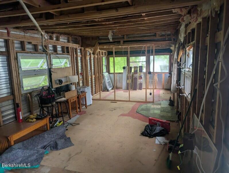 155 Water Street, Unit 5 Lee, MA 01238 - Photo 5 of 6 a view of a porch with furniture and floor to ceiling window