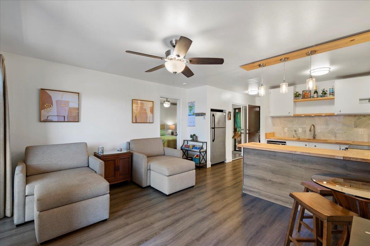 a living room with furniture and a wooden floor