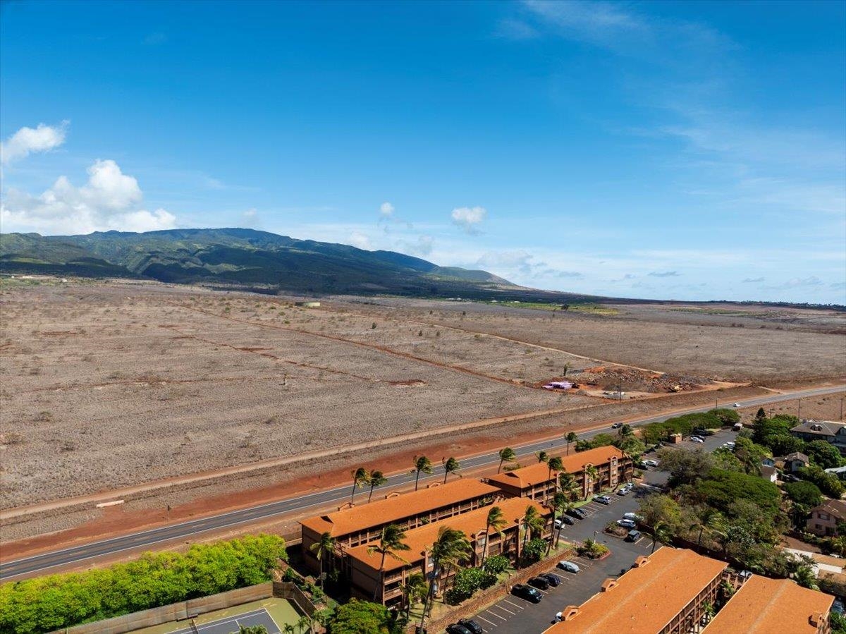 3740 Lower Honoapiilani Road, Unit E102 Lahaina, HI 96761 - Photo 12 of 41 a view of an ocean beach and mountain