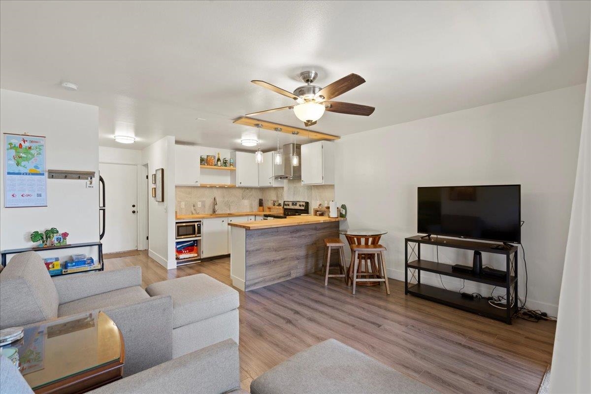3740 Lower Honoapiilani Road, Unit E102 Lahaina, HI 96761 - Photo 20 of 41 a living room with furniture and a flat screen tv