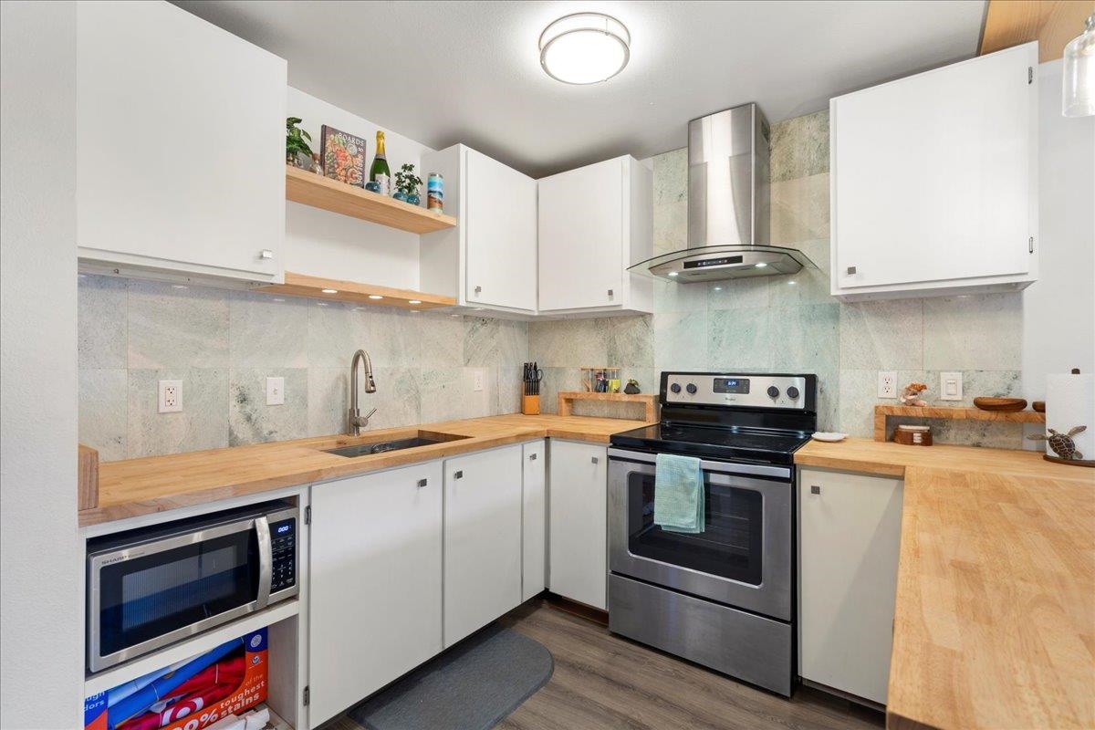 3740 Lower Honoapiilani Road, Unit E102 Lahaina, HI 96761 - Photo 24 of 41 a kitchen with stainless steel appliances granite countertop a sink and a stove