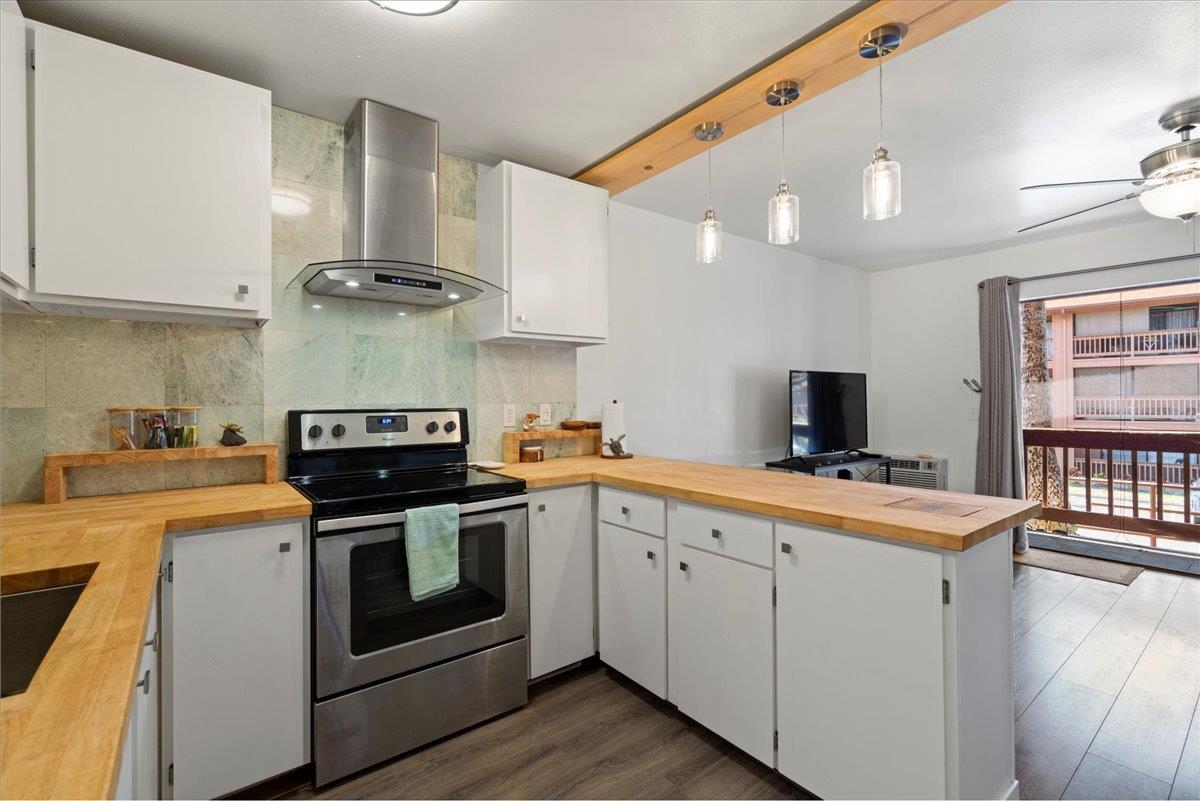 3740 Lower Honoapiilani Road, Unit E102 Lahaina, HI 96761 - Photo 25 of 41 a kitchen with a stove and a sink