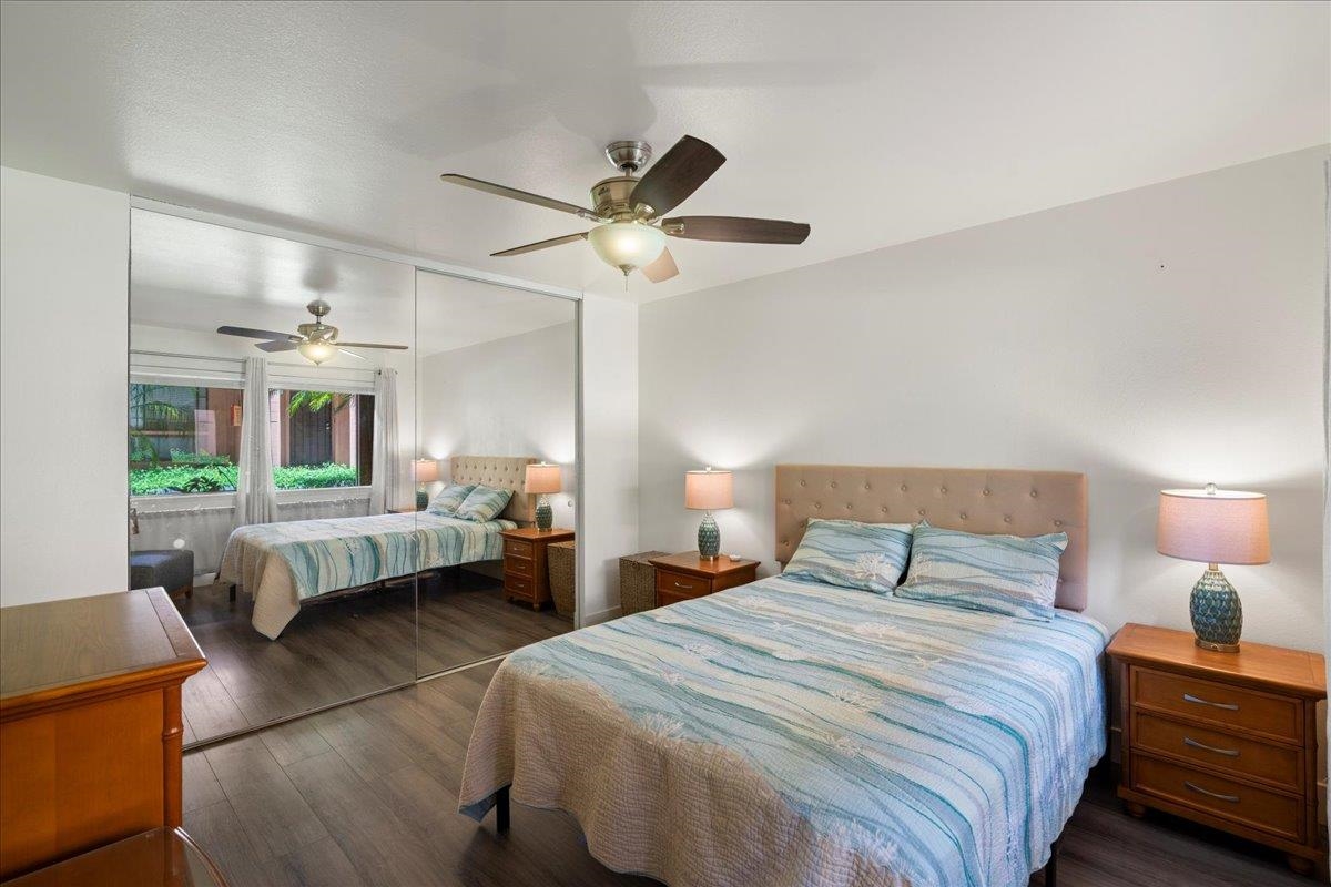 3740 Lower Honoapiilani Road, Unit E102 Lahaina, HI 96761 - Photo 34 of 41 a bedroom with a bed and a chandelier