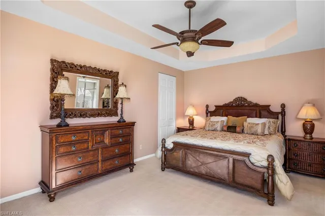 a bedroom with a bed and a mirror on the dresser