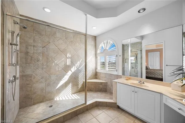 a spacious bathroom with a sink mirror and a shower