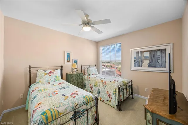 a bedroom with two beds and a table